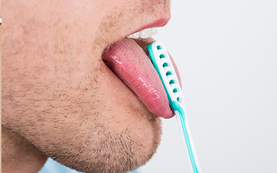 A man cleaning his tongue