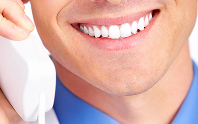 up-close smile while holding a phone