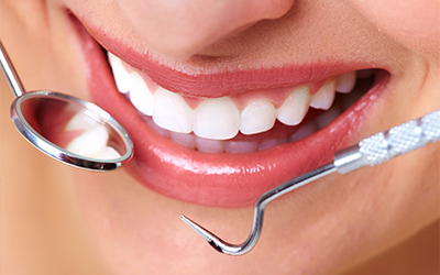Up-close smile with dental tools