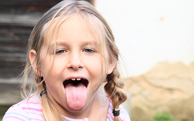 A young girl sticking her tongue out