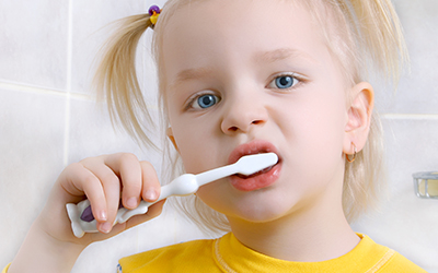 Young girl brushing her teeth